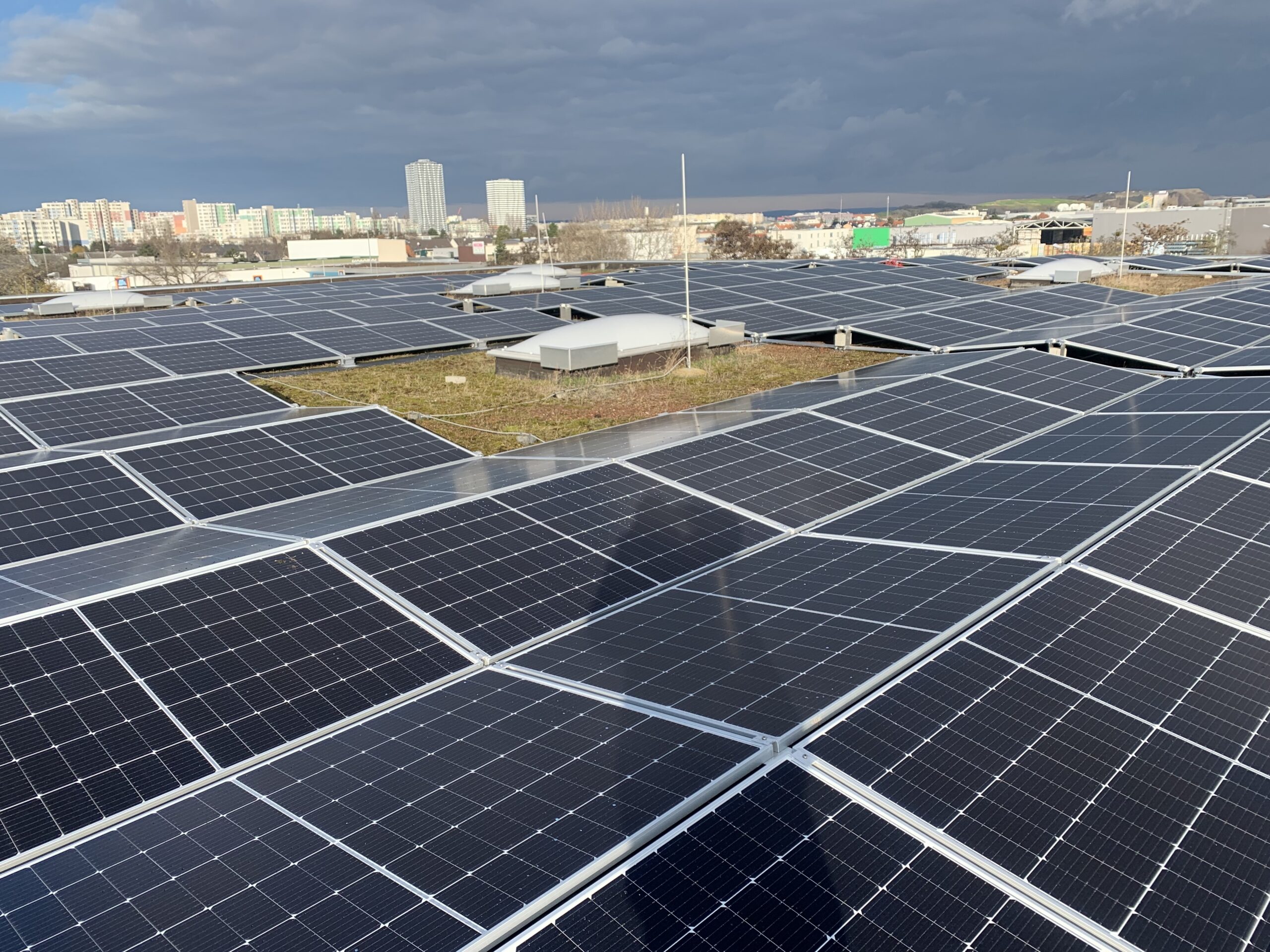 Commercial solar panel installation on a green roof in an urban area for sustainable energy generation
