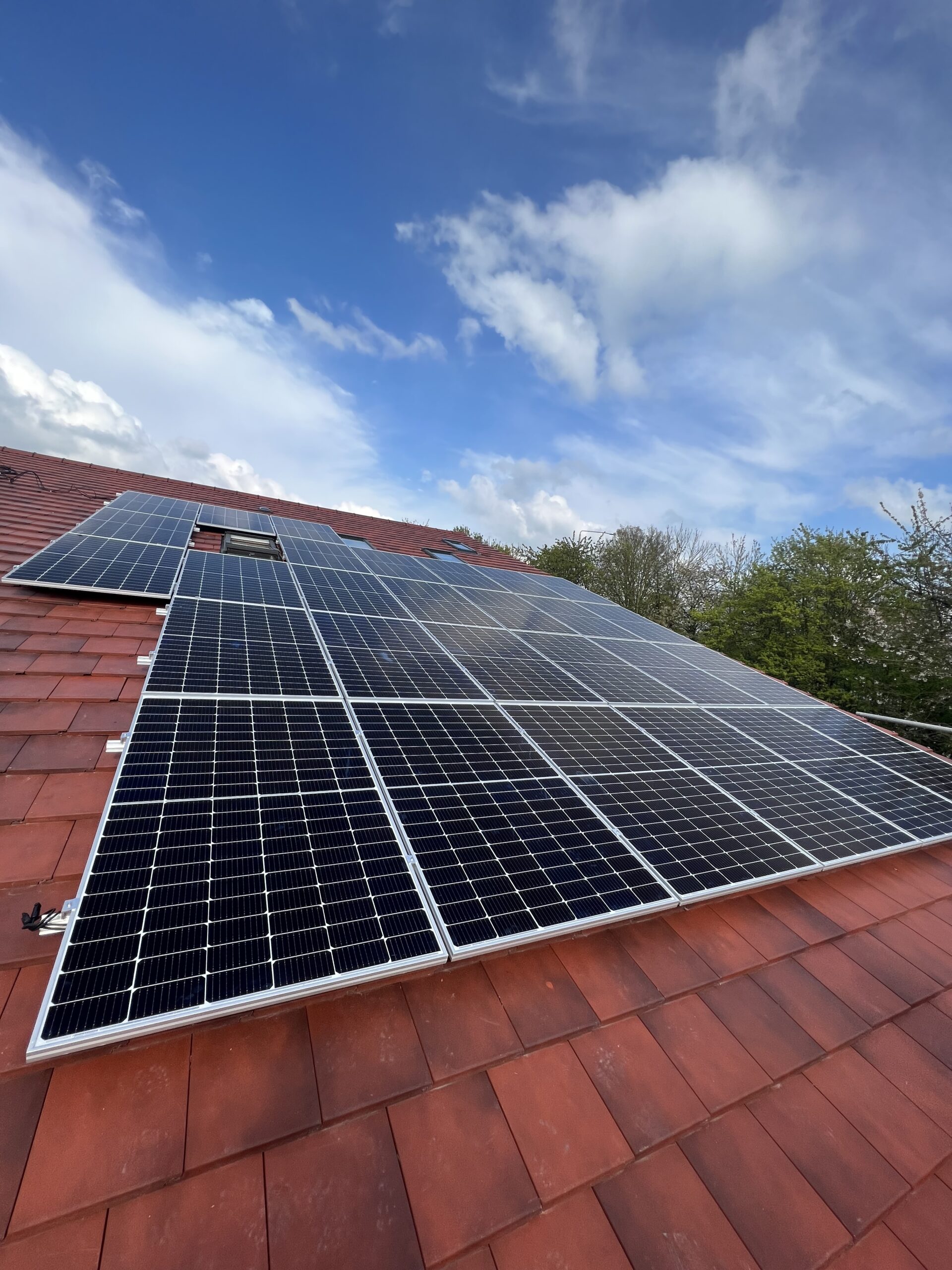 Commercial solar panel installation on a tiled roof for sustainable energy solutions.