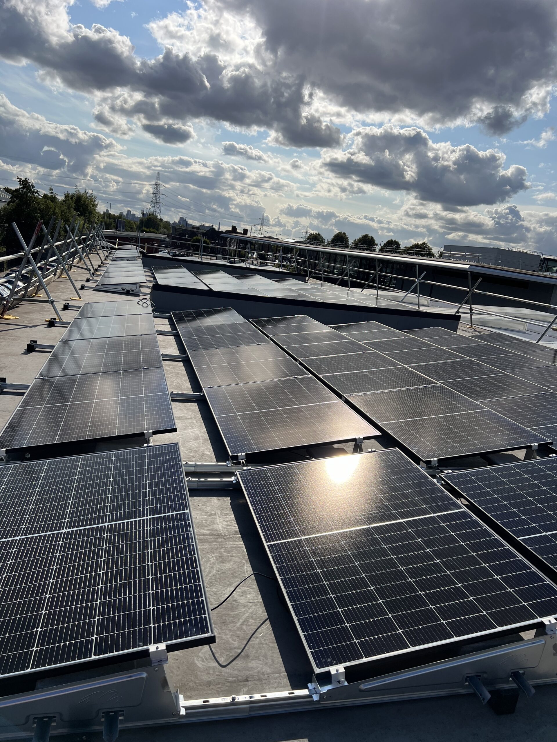 Flat roof ballasted solar panel installation on a commercial building for renewable energy production