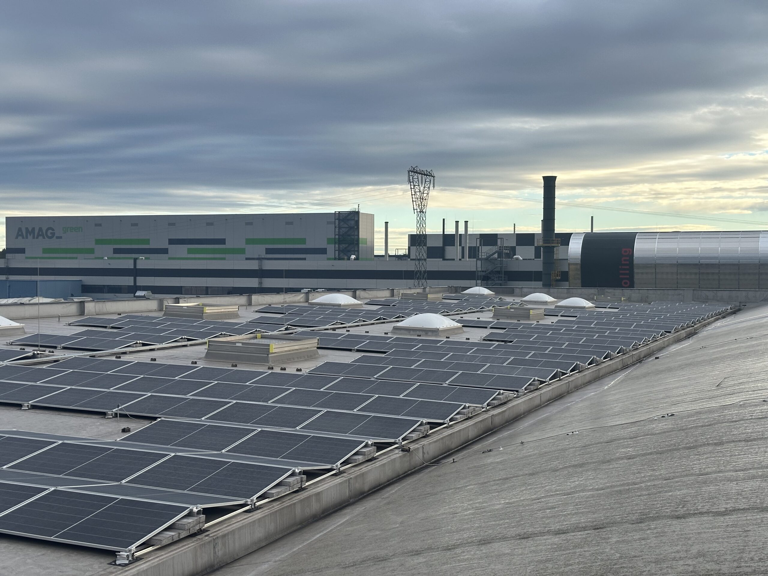 Large-scale industrial flat roof solar panel installation for renewable energy production in a commercial facility.